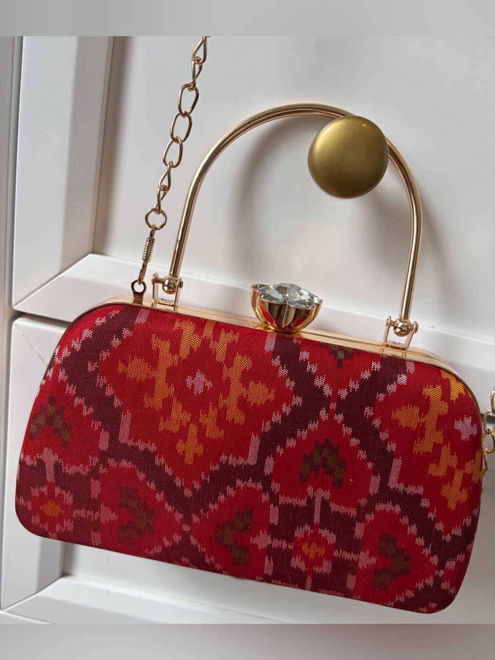 Red Patterned Evening Clutch with Gold Hardware and shoulder chain strap include